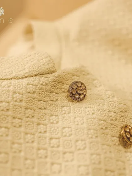 Another detail of the textured fabric and custom buttons. The self-woven pattern provides a rich canvas, making the buttons stand out as pieces of jewelry.