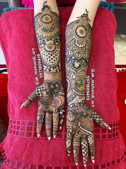 A perfectly symmetrical view of a full bridal mehndi design, highlighting the intricate patterns on both hands and arms.