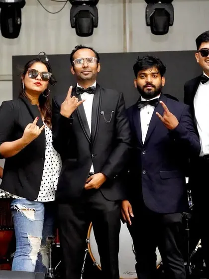The full band in our classic black-tie attire, ready to rock the stage. This look is perfect for formal corporate functions and award ceremonies.