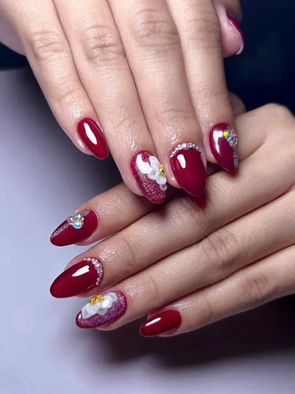 A glamorous and festive set in deep red, featuring 3D flowers, sparkling glitter, and a cascade of rhinestones.