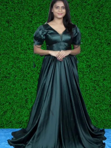 This elegant dark green satin gown features puff sleeves and a flowing A-line skirt. The rich fabric and color create a look of pure sophistication.