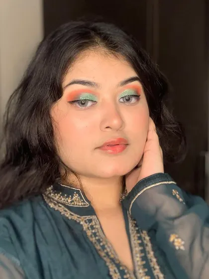 A creative look with orange and green eyeshadow.