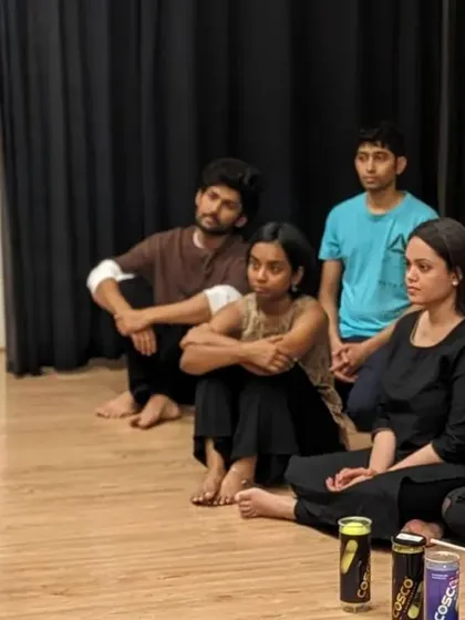 A group listens intently as our founder, Sahiba, explains a concept in an intuitive movement workshop. These sessions are deeply educational and experiential.