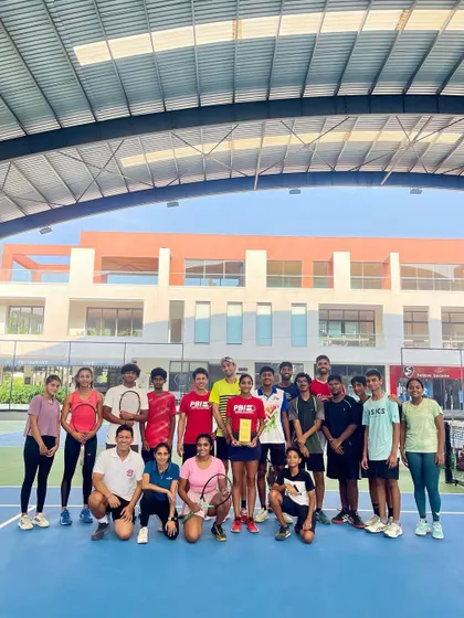 The PBI family celebrates a player's AITA Doubles Championship. Her victory is a victory for the entire team that supported her journey.