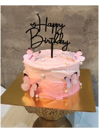 A simple yet beautiful butterfly cake with a pink ombre buttercream finish. It's a lovely choice for a birthday celebration.