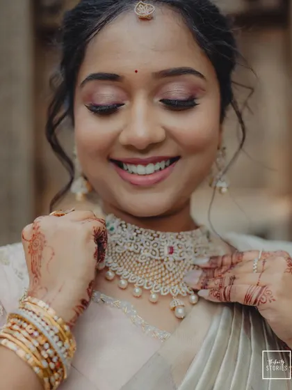 A beautiful close-up of the bride smiling, capturing a moment of pure happiness and anticipation.