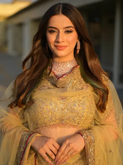 Bathed in the golden hour light, this bride looks absolutely radiant. Her soft, traditional makeup is perfect for a daytime wedding or outdoor event.