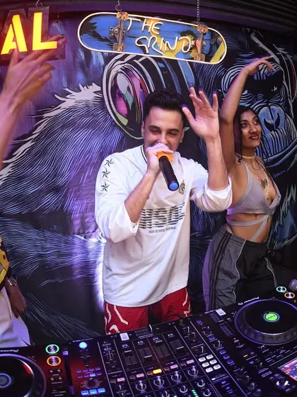 Guest performers hyping the crowd from the DJ booth. It's an interactive experience.
