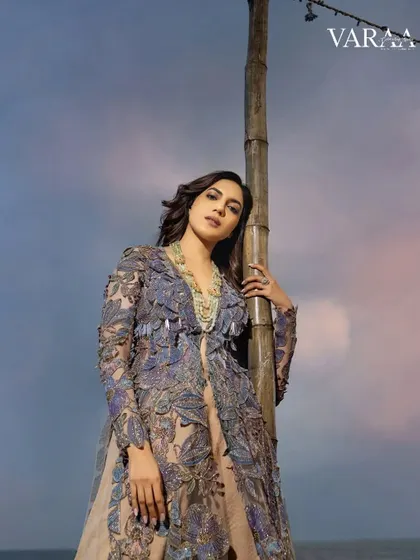 A beautiful close-up of the embroidered jacket look from the Varaa shoot. The soft light of the evening sky complements the delicate colors and textures of the floral embroidery, creating a romantic and ethereal mood.