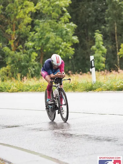 The focus required during a tough bike leg. Rain, fog, and cold make it a mental game as much as a physical one.
