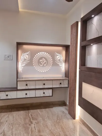 The backlit 'Om' symbol with peacock feathers adds a spiritual and artistic touch to this custom-designed media and pooja unit.