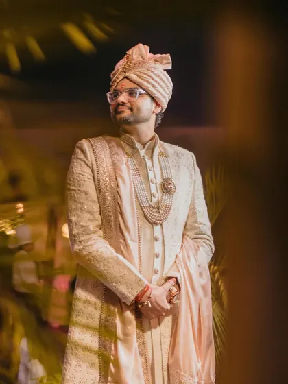 A classic portrait of the groom in his elegant sherwani, looking ready to meet his bride.