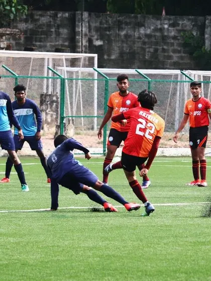 A well-timed slide tackle from one of our defenders. I teach my players to be strong and decisive in their defensive duties.