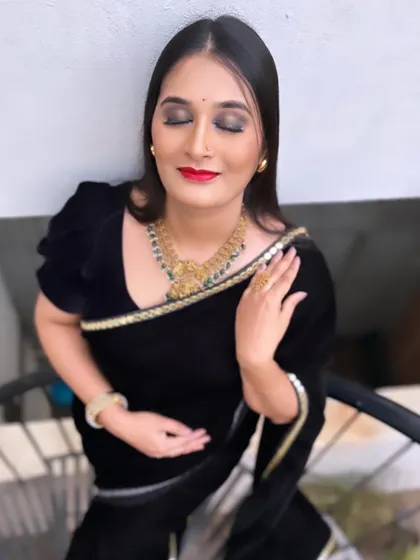 A classic combination of a black saree and red lipstick. For this look, I created a sharp winged liner and a bold red lip, giving it a timeless and elegant feel. The eyeshadow is a soft brown shimmer, adding depth without being too heavy.