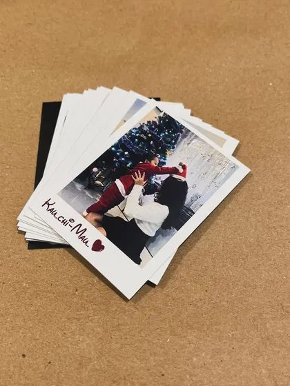 A stack of polaroid prints with a handwritten message, showing how they can be personalized even further.