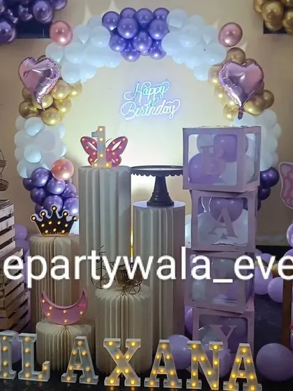 A butterfly theme with a purple, white, and gold color scheme, featuring wooden crates and other rustic props.