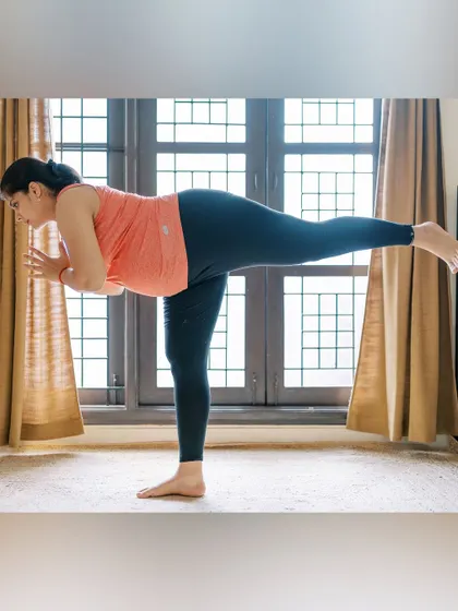 This is me practicing a modified Warrior III (Virabhadrasana III) during my pregnancy. Balancing poses were my favorite for maintaining mental focus and physical stability. My personal practice informs everything I teach.