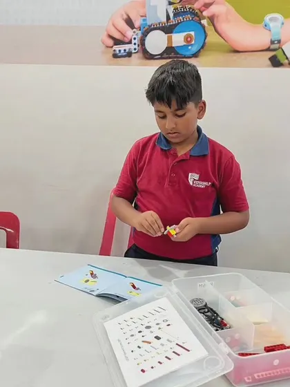 A student at Vidyashilp Academy carefully follows the instructions to build his model, developing patience and attention to detail.