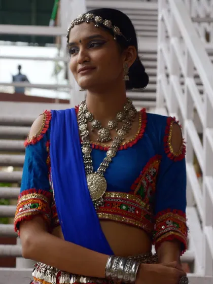 This close-up shows a stunning layered oxidized silver necklace, a must-have accessory for an authentic Garba look.