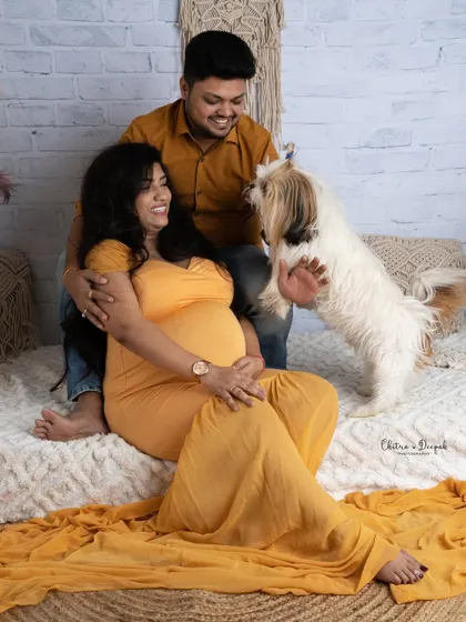 Paws-itively excited! This playful shot with the family dog jumping up shows the fun and love that pets bring to a family.