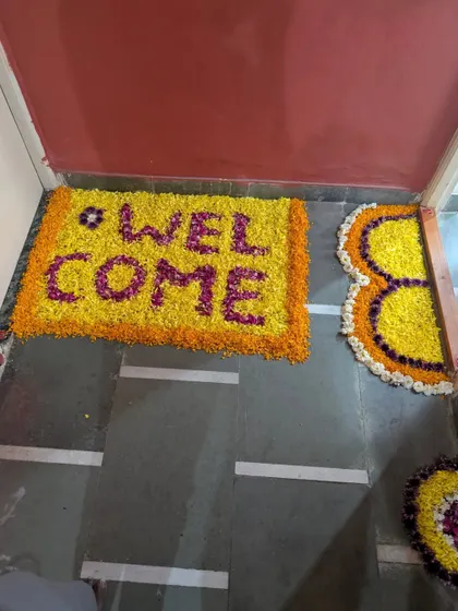A traditional welcome with a flower rangoli mat at the doorstep. This beautiful arrangement of marigold and rose petals is a classic way to greet guests and the new baby.