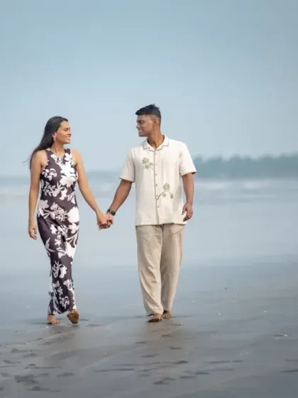A serene walk along the shore during a pre-wedding shoot. The misty background and calm water create a peaceful and romantic atmosphere for this couple portrait.