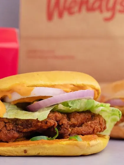 A classic fried chicken burger from Wendy's, shot to look juicy and delicious. We focused on the crispy texture of the chicken and the fresh toppings to create a mouth-watering commercial image.