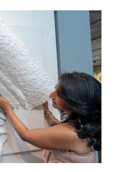 The final touches on "The Flight of Knowledge." The layered pages seem to lift off the canvas, symbolizing knowledge taking flight into the world.