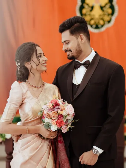 The look of love. This Christian wedding portrait captures the couple sharing a happy, knowing glance after their ceremony.