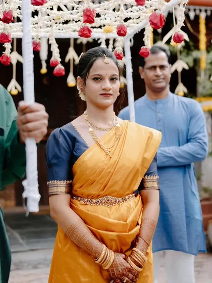 The bride making her entrance. The makeup is traditional and elegant, fitting the solemnity of the occasion.