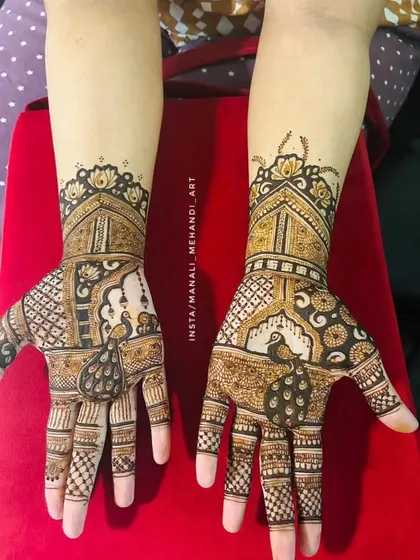This is one of my favorite designs, featuring detailed peacock and jharokha architecture motifs. It's a perfect example of the rich, full-hand mehandi I create for wedding guests and family members who want an elaborate look.