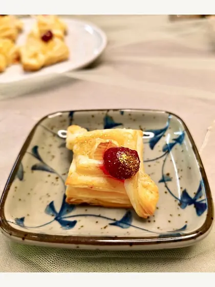 A delicate Brie & Cranberry Puff Pastry bite. This appetizer from our continental menu offers a perfect balance of creamy, sweet, and flaky textures.