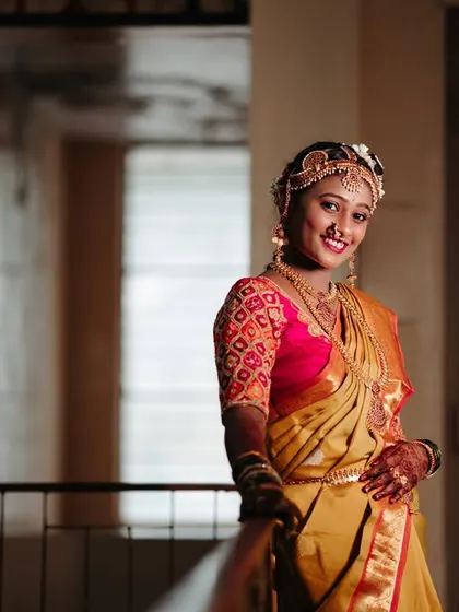 A smiling portrait of the bride, Shrivalli, looking elegant in her wedding saree. The soft lighting is very flattering.