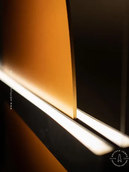A study in balance and contrast, this fixture features opposing black and gold panels bisected by a line of light. This piece embodies the principle of yin and yang, offering a minimalist yet deeply symbolic lighting solution.