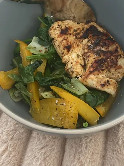 Another look at a client's anti-inflammatory meal: grilled chicken with spinach and yellow peppers. Consistency with meals like this leads to the best results.