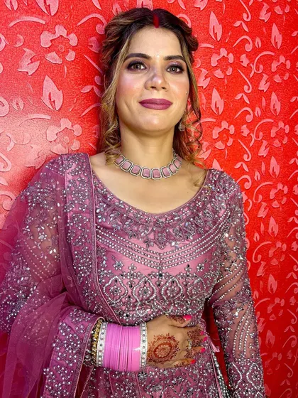 Another shot of the magenta lehenga, showing the intricate silver embroidery and the traditional bangles.