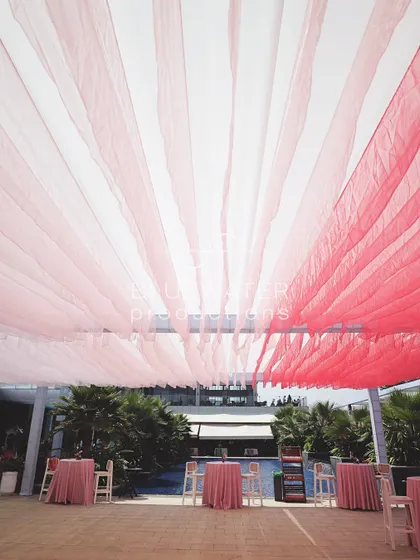 The organza drapes create beautiful stripes of color against the sky.