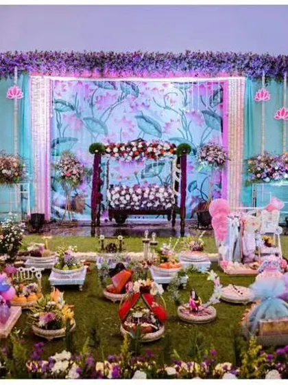 A wide view of a beautiful baby shower event we provided gifts for. Our curated collection of gift platters and hampers in the foreground complements the stage decor, creating a cohesive and festive atmosphere for the celebration.