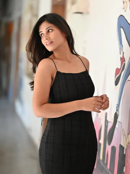 A candid-style moment from a fashion shoot. These in-between moments often result in the most natural and beautiful shots, showing a model's relaxed presence.