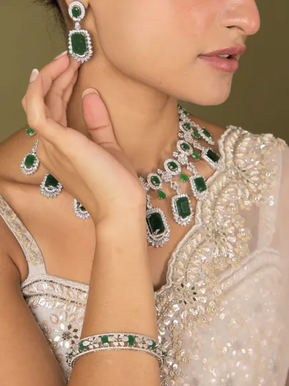 A detailed shot of our emerald and diamond-look set, showing the necklace, earrings, and bangles together.