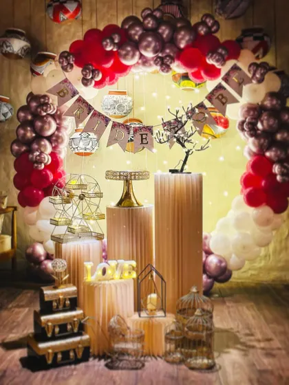 A unique birthday theme with red and chrome balloons, a 'Bride' banner, and hanging paper lanterns for a fusion look.