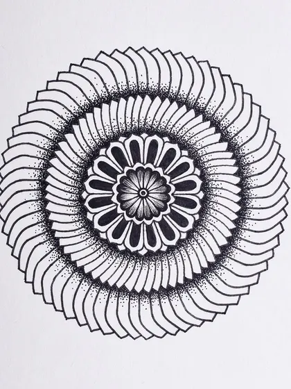 Two small mandalas from my Inktober series. The top one has a layered, blade-like pattern, while the bottom one features a softer, floral design.
