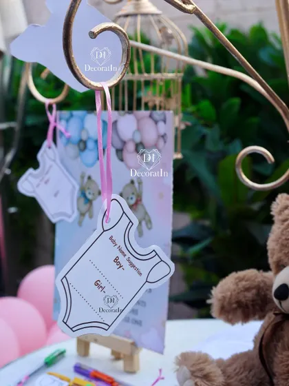A close-up of the baby name suggestion cards, shaped like little onesies.