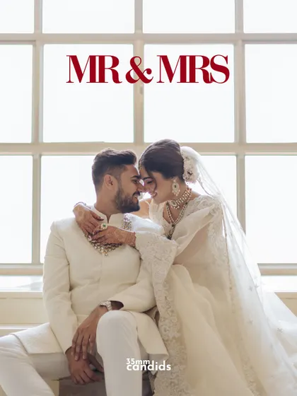 Mr. & Mrs. A beautifully lit portrait of the newlyweds, capturing an intimate moment of connection and joy against a bright, airy window.