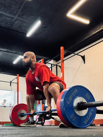 Locked in and focused. These shots capture the intensity and determination of our members during their workouts, from band work and deadlifts to dumbbell presses and rowing.