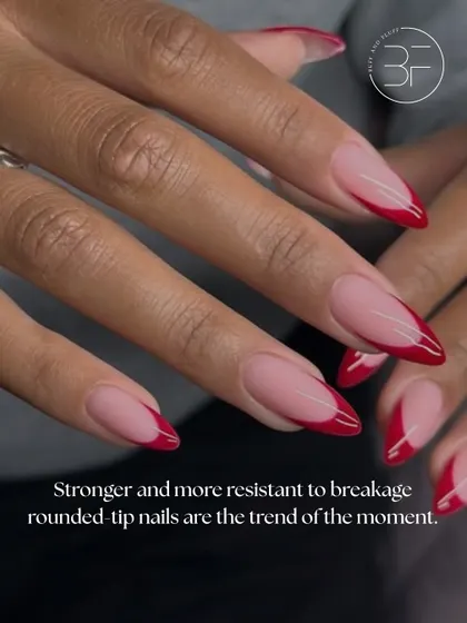 A closer look at an almond-shaped nail with a chic red French tip. This shape is strong, resistant to breakage, and always in style.
