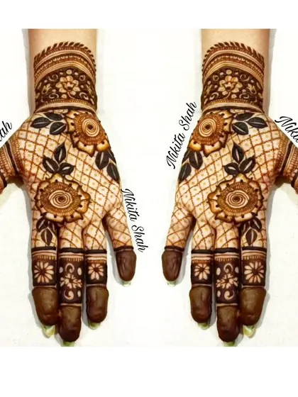 A lovely Indo-Western design with floral motifs on a net background. The dark leaves create a beautiful contrast.