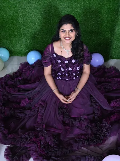 A lovely seated portrait of a client in our dark purple ruffle gown. The full skirt spreads out beautifully, creating a very elegant and regal look.