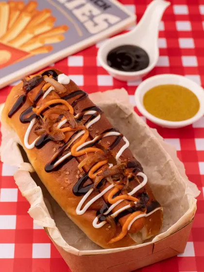 A beautifully styled hot dog, drizzled with an array of sauces. We shot this for a brand specializing in gourmet hot dogs, using a classic diner-style setup to evoke a sense of nostalgia and fun.