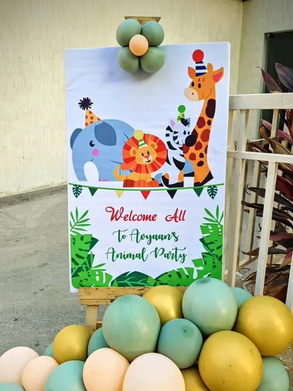 A personalized welcome sign for Avyaan's animal-themed party. The sign features cute cartoon animals and is surrounded by balloons, making it a cheerful first impression for guests.